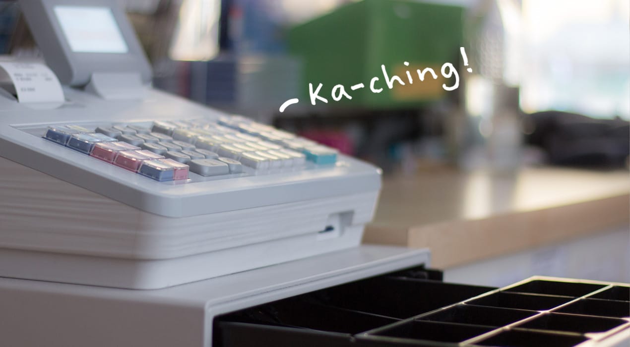 Open cash register with the word "ka-ching" off to the side