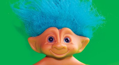 Troll with blue hair against green background