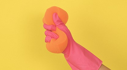 Hand in glove squeezing cleaning sponge
