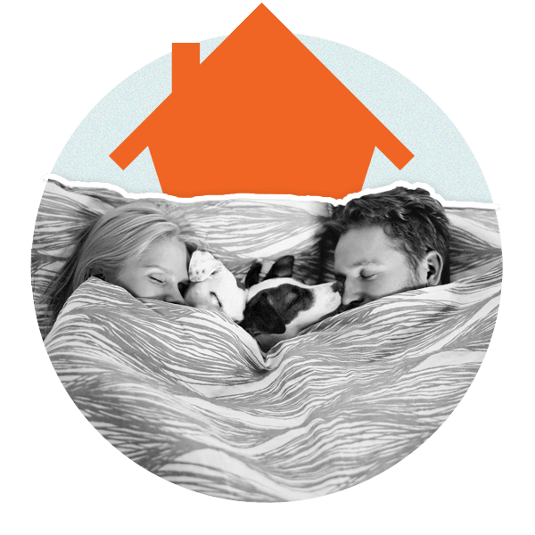 Woman and man with dog lying in bed