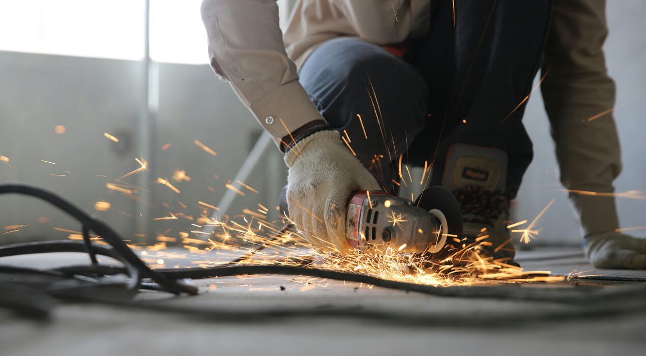 Person using a small circular saw to cut materials on a construction site