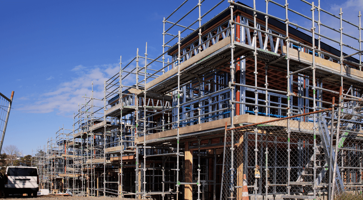 Townhouses under construction, covered in scaffolding