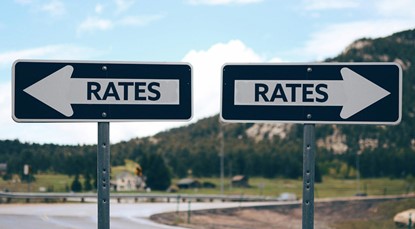 Rates road signs pointing opposite directions