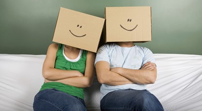 Young couple with boxes on heads