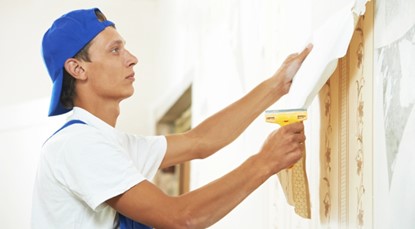 Tradesman stripping wallpaper