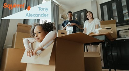 Family in house, cardboard boxes with child in the foreground