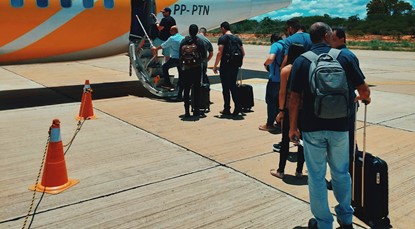 People lining up to board an airplane