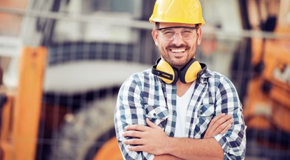 Man in construction gear smiling at camera
