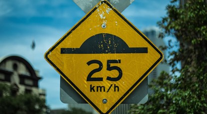 Speed bump sign, 25km/h ahead