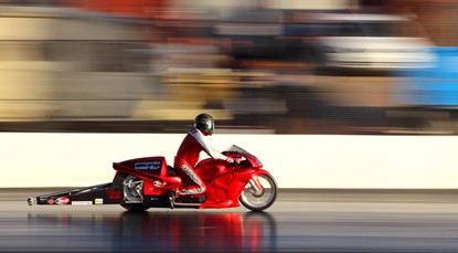 Red motorcycle, speeding