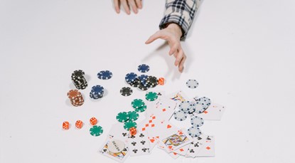 Poker chips and cards, hand reaching out